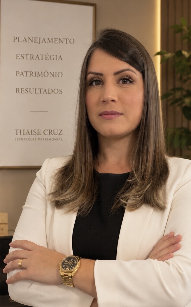 Thaise Cruz, consultora de estratégia patrimonial, de blazer branco e braços cruzados